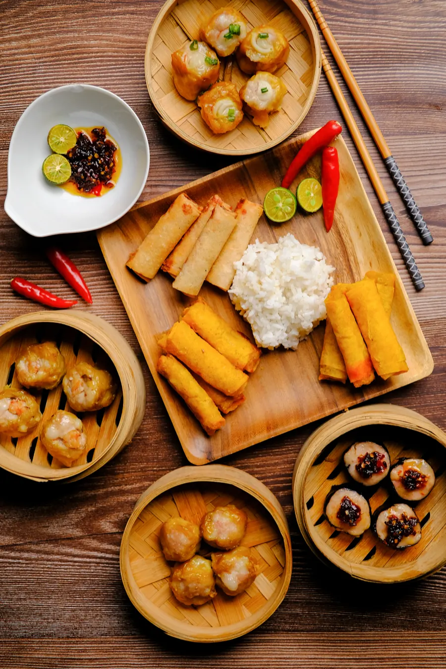 A party spread of siomai, Japanese siomai, lumpia and rice with chili and calamansi