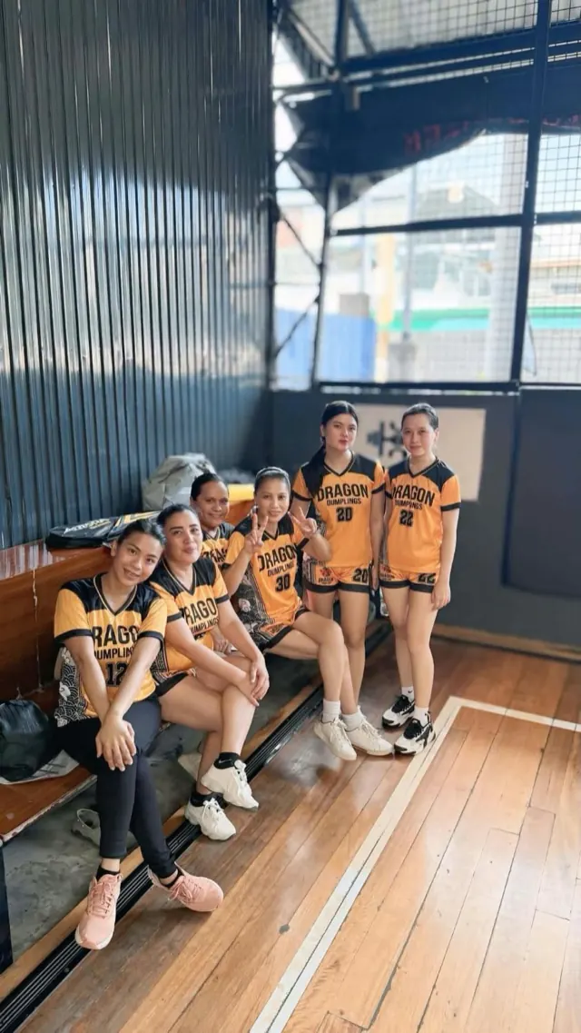 Six members of the Dragon Dumplings women's team courtside