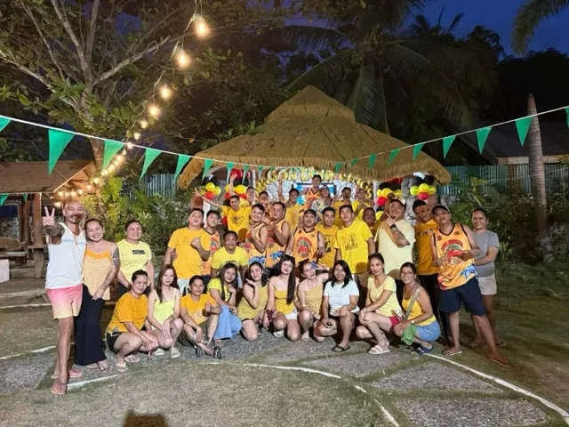 The Dragon Dumplings team at a night party, everyone dressed in yellow